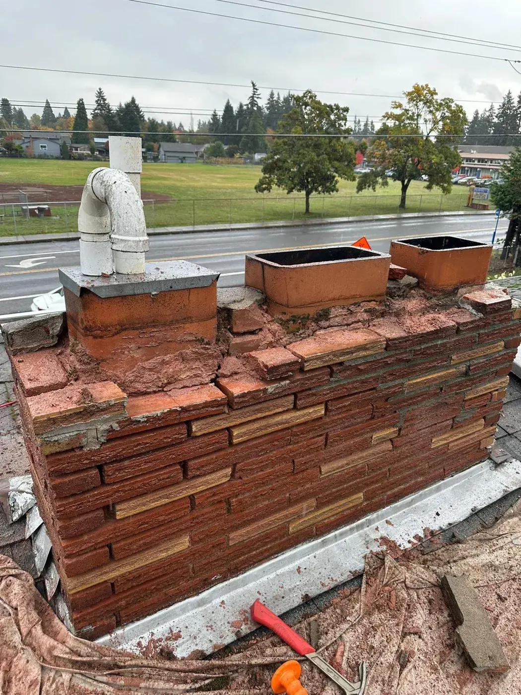 Crumbling Stack & Exposed Flue Tiles → Rebuilt Brick, New Crown & Three New Caps before